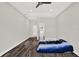 Empty bedroom featuring hardwood floors, ceiling fan, tray ceiling, and bright lighting at 17838 Morninghigh Dr, Lutz, FL 33549