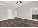 Spacious bedroom features modern ceiling fan, wood-look tile flooring, and access to a bathroom at 17838 Morninghigh Dr, Lutz, FL 33549