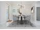 Bright dining room with modern chandelier, dining table, and view to outdoor living space at 17838 Morninghigh Dr, Lutz, FL 33549