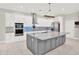 Kitchen features white cabinets, stainless appliances, and a gray island with granite counter tops at 17838 Morninghigh Dr, Lutz, FL 33549