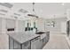 Kitchen island with granite countertops, stainless steel sink and decorative lighting at 17838 Morninghigh Dr, Lutz, FL 33549