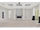 Spacious living room with tile flooring, modern fireplace, and ceiling fan at 17838 Morninghigh Dr, Lutz, FL 33549