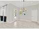 Living room features modern lighting and view to outdoor living space with tiled flooring at 17838 Morninghigh Dr, Lutz, FL 33549
