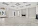 Expansive living area boasts tile flooring, fireplace, and abundant natural light from large windows at 17838 Morninghigh Dr, Lutz, FL 33549