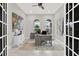 Bright office with white trim, modern finishes, arched windows and neutral paint and flooring at 17838 Morninghigh Dr, Lutz, FL 33549