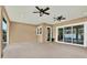 Spacious covered patio featuring dual ceiling fans and convenient access to both the yard and interior at 17838 Morninghigh Dr, Lutz, FL 33549