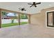 Spacious, covered patio with ceiling fans and views of the fenced yard and landscape at 17838 Morninghigh Dr, Lutz, FL 33549