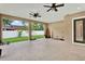 Large covered patio with ceiling fans, recessed lighting, and a view to the yard and property line at 17838 Morninghigh Dr, Lutz, FL 33549