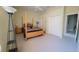 Bright bedroom featuring a four-poster bed, neutral carpeting and ample closet space at 18434 Eastwyck Dr, Tampa, FL 33647