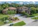 Two-story home with a well-manicured lawn, mature trees and attractive desert landscaping at 18434 Eastwyck Dr, Tampa, FL 33647