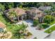 A well maintained home with a large driveway, mature trees and attractive desert landscaping at 18434 Eastwyck Dr, Tampa, FL 33647
