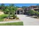 Charming two-story home with well-maintained landscaping, palm trees, and a long concrete driveway at 18434 Eastwyck Dr, Tampa, FL 33647