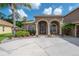 Charming home featuring an arched entry, desert landscaping, and brick lined porch at 18434 Eastwyck Dr, Tampa, FL 33647