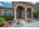 Arched entry with attractive landscaping and a cozy seating area on the brick-lined porch at 18434 Eastwyck Dr, Tampa, FL 33647