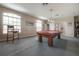 Spacious game room with a pool table, carpeted flooring, and natural light at 18434 Eastwyck Dr, Tampa, FL 33647