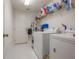 Well-lit laundry room with modern washer and dryer and ample storage space at 18434 Eastwyck Dr, Tampa, FL 33647