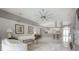 Open living area featuring tile flooring, white sofas, contemporary decor, and a glimpse into the kitchen at 18434 Eastwyck Dr, Tampa, FL 33647