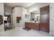 Main bathroom with double vanity, and a doorway into the Primary bedroom at 18434 Eastwyck Dr, Tampa, FL 33647
