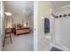 Spacious main bedroom featuring a four-poster bed, neutral carpet, and a ceiling fan at 18434 Eastwyck Dr, Tampa, FL 33647