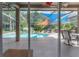Gorgeous screened-in pool area with a waterfall feature, lounge chairs, and hot tub at 18434 Eastwyck Dr, Tampa, FL 33647