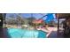 Screened-in pool area with rock waterfall, lounge chairs, and a relaxing hot tub at 18434 Eastwyck Dr, Tampa, FL 33647