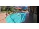 Sparkling pool with rock waterfall feature and screened enclosure, perfect for outdoor enjoyment at 18434 Eastwyck Dr, Tampa, FL 33647