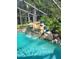 Beautiful pool with a charming rock waterfall feature at 18434 Eastwyck Dr, Tampa, FL 33647