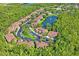 Aerial view of the community showcasing the lake, fountain, and mature trees at 18809 Duquesne Dr, Tampa, FL 33647