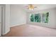 Spacious bedroom with plush carpet, lots of light, and a picturesque view at 18809 Duquesne Dr, Tampa, FL 33647