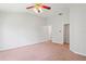 Bright bedroom with neutral walls, carpeted floors, ceiling fan and ample natural light at 18809 Duquesne Dr, Tampa, FL 33647