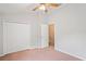 This bedroom features a closet, ceiling fan, and adjacent doorway at 18809 Duquesne Dr, Tampa, FL 33647