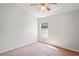 This bedroom boasts neutral walls, a single window, and plush carpet at 18809 Duquesne Dr, Tampa, FL 33647