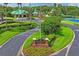Entrance to Community Club, lush lawns, mature trees, and facilities, including a pool and tennis courts at 18809 Duquesne Dr, Tampa, FL 33647