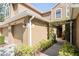 Welcoming townhome entrance with an arched pergola and tan stucco exterior at 18809 Duquesne Dr, Tampa, FL 33647