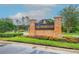 Brick community sign with manicured landscaping and flowering plants at 18809 Duquesne Dr, Tampa, FL 33647