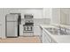Bright kitchen with stainless steel appliances, white cabinets, and modern hardware at 18809 Duquesne Dr, Tampa, FL 33647