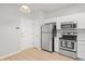 Well-lit kitchen featuring stainless steel appliances, white cabinetry, and stylish lighting at 18809 Duquesne Dr, Tampa, FL 33647
