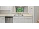 Bright kitchen featuring stainless steel appliances and white cabinets, with a view to outdoors at 18809 Duquesne Dr, Tampa, FL 33647