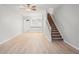 Spacious living room with hardwood floors, stairs, and an open concept leading to the kitchen at 18809 Duquesne Dr, Tampa, FL 33647