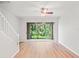 Spacious living room with light-colored hardwood floors and a sliding glass door to outdoors at 18809 Duquesne Dr, Tampa, FL 33647