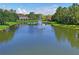 A tranquil pond with a fountain in the center, surrounded by lush green lawns and residential buildings at 18809 Duquesne Dr, Tampa, FL 33647