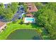 Aerial view of a community pool with a cabana, surrounded by lush greenery and parking at 18809 Duquesne Dr, Tampa, FL 33647