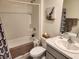 Cozy bathroom featuring a tub with shower, neutral tile, and a framed mirror at 1905 Blue Stream St, Ruskin, FL 33570
