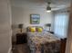 Bright bedroom featuring a queen bed with decorative pillows, side tables with lamps, and sheer curtains at 1905 Blue Stream St, Ruskin, FL 33570