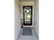 Inviting entryway with a wreath-adorned glass door, a decorative mat, and a whimsical statue at 1905 Blue Stream St, Ruskin, FL 33570