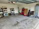 Spacious garage with ample room for storage and vehicles, featuring shelving units at 1905 Blue Stream St, Ruskin, FL 33570