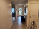 Inviting hallway with tiled flooring, a bench seat, and a decorative front door at 1905 Blue Stream St, Ruskin, FL 33570