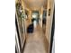 Welcoming hallway with tile flooring, stylish bench, and views of the dining and living areas at 1905 Blue Stream St, Ruskin, FL 33570