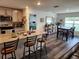 Bright kitchen with a center island, stainless steel appliances, and open dining area at 1905 Blue Stream St, Ruskin, FL 33570