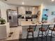 Modern kitchen featuring stainless steel appliances and a large center island with bar seating at 1905 Blue Stream St, Ruskin, FL 33570